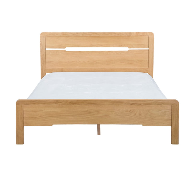 Wooden bed frame with white mattress on a white background