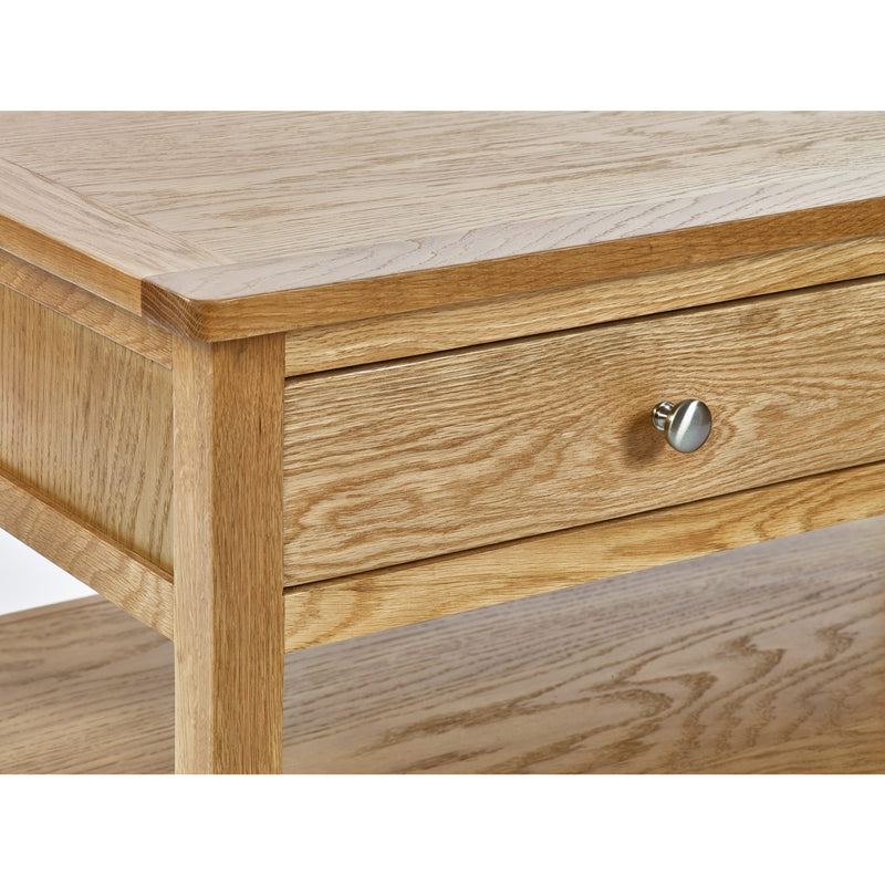 Wooden coffee table with a drawer and metal handle on a white background