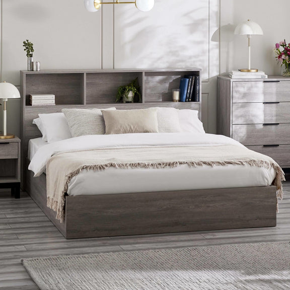 Bedroom with a wooden bed frame, white bedding, and nightstands.