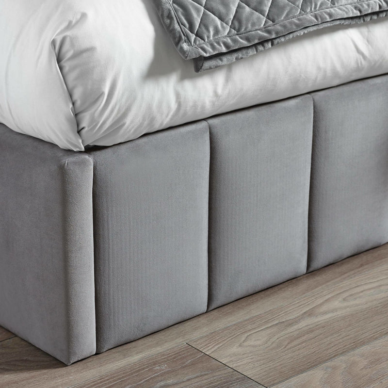 Gray upholstered bed frame with wooden flooring