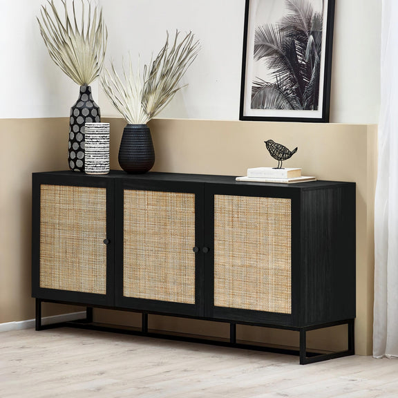 Black sideboard with woven doors in a room with decorative items.