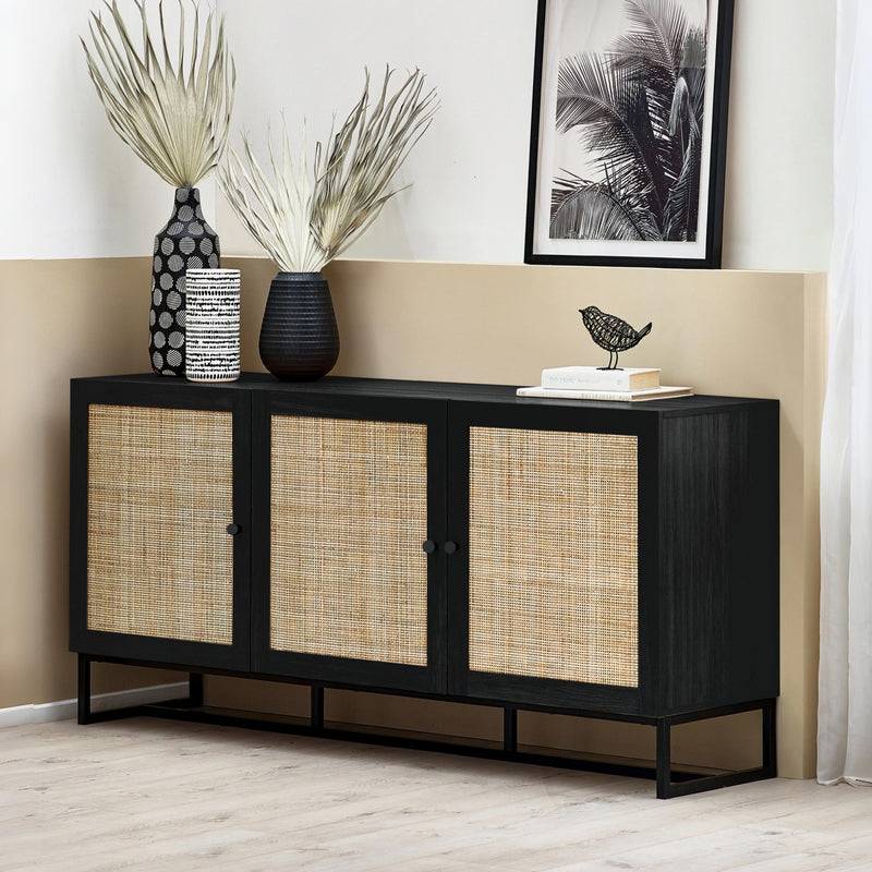 Black sideboard with woven doors in a room with decorative items.