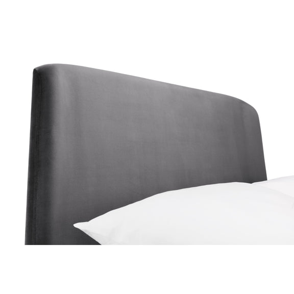 Gray upholstered headboard with a white pillow on a white background