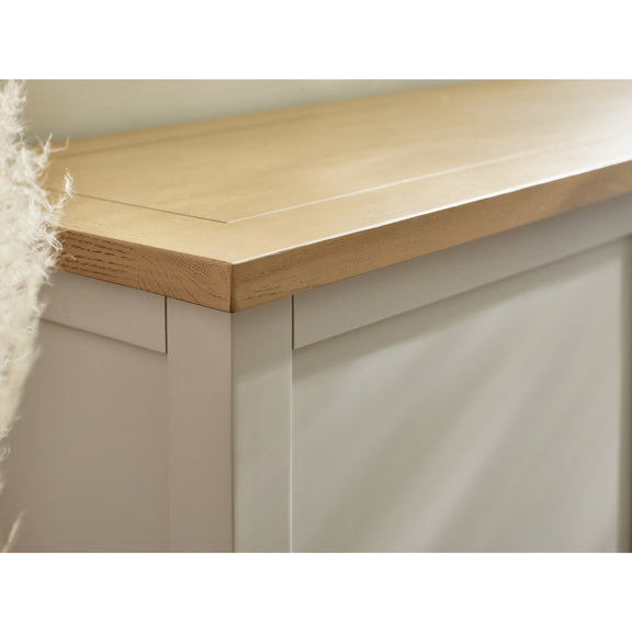 Close-up of a wooden desk corner with a light finish.