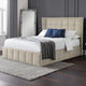 Beige upholstered bed with white bedding and blue pillows in a bedroom setting.