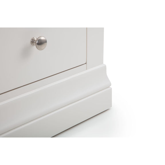 Close-up of a white dresser with a silver knob on a white background