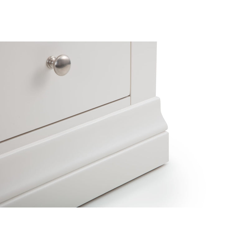 Close-up of a white dresser with a silver knob on a white background
