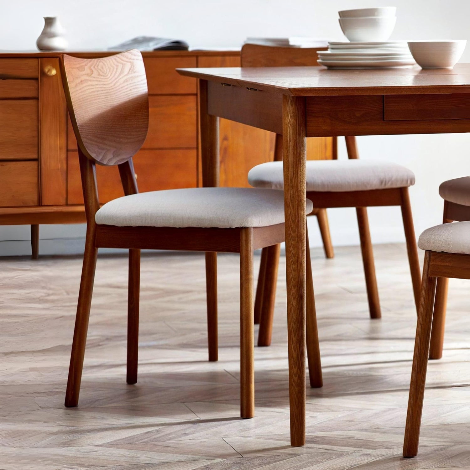 Wooden dining table with chairs in a room setting