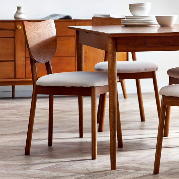 Wooden dining table with chairs in a room setting