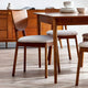 Wooden dining table with chairs in a room setting