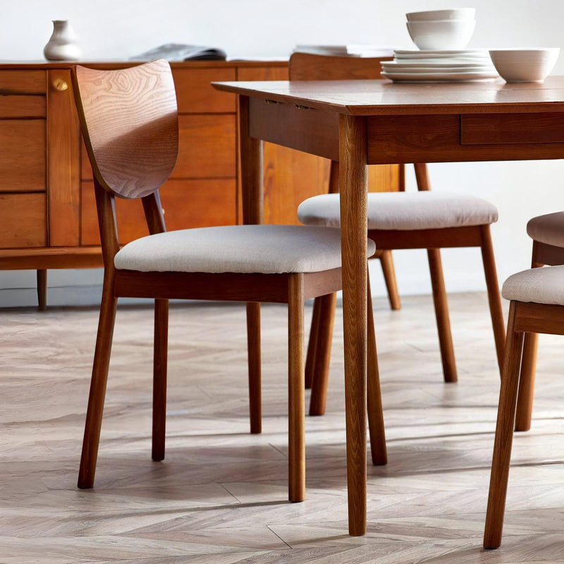 Wooden dining table with chairs in a room setting