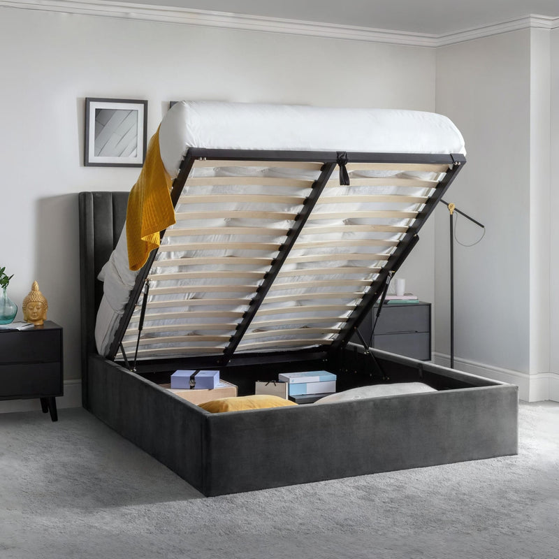 Gray upholstered bed with open storage compartment in a bedroom setting