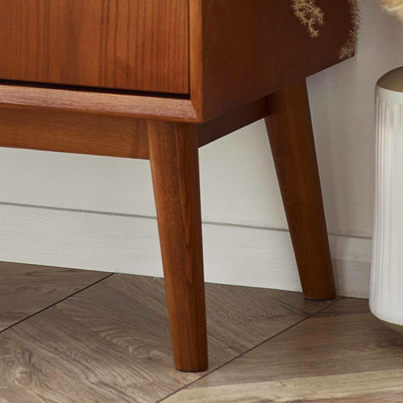Wooden furniture leg on a wooden floor with a neutral background