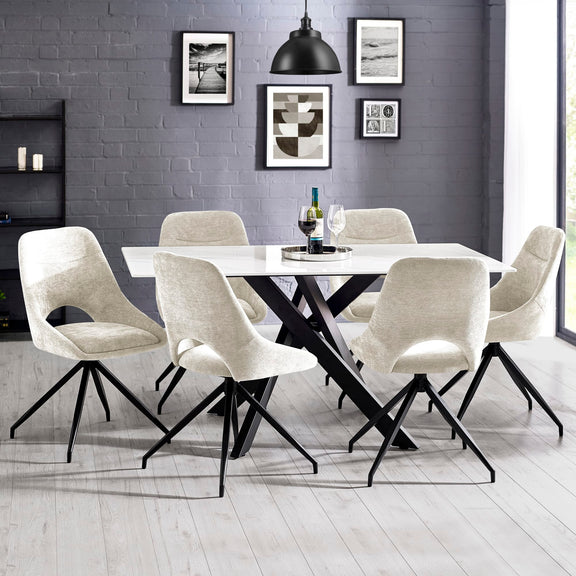 Dining room with a black and white table and chairs against a gray brick wall.