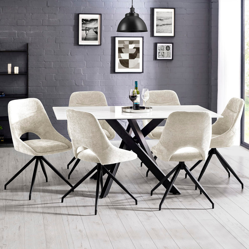 Dining room with a black and white table and chairs against a gray brick wall.