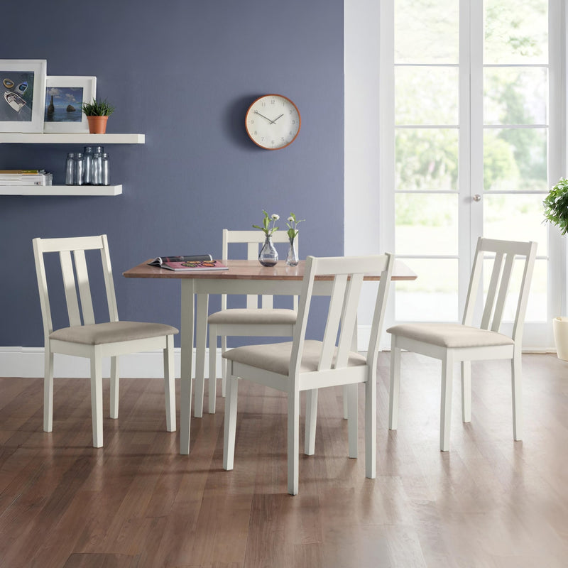 Dining room with a wooden table and white chairs against a blue wall.