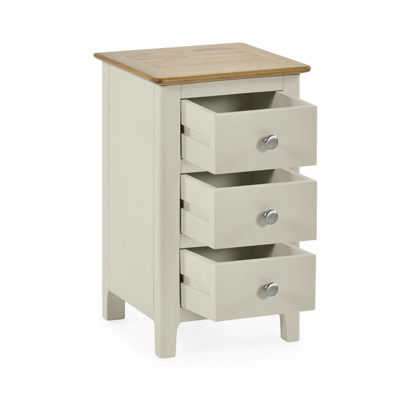 White wooden bedside table with all three drawers open for storage