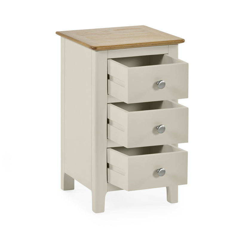 White wooden bedside table with all three drawers open for storage