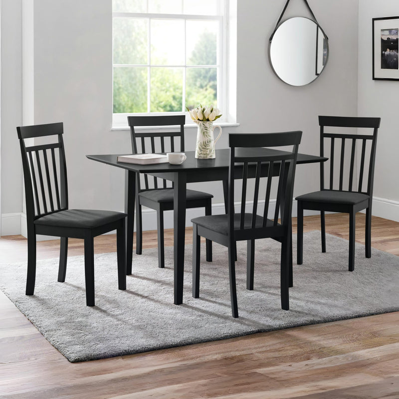 Black dining set with table and chairs in a room with a window and mirror.