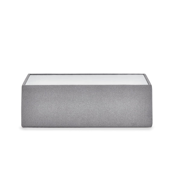 Gray fabric ottoman with glass top on a white background