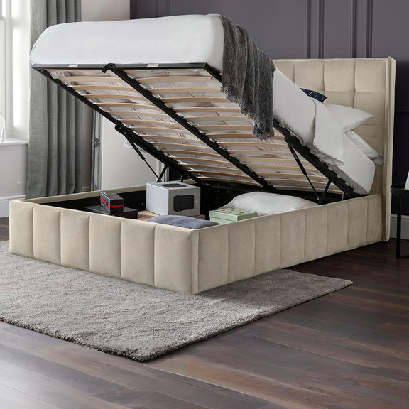 Beige upholstered bed with storage compartments in a room setting.