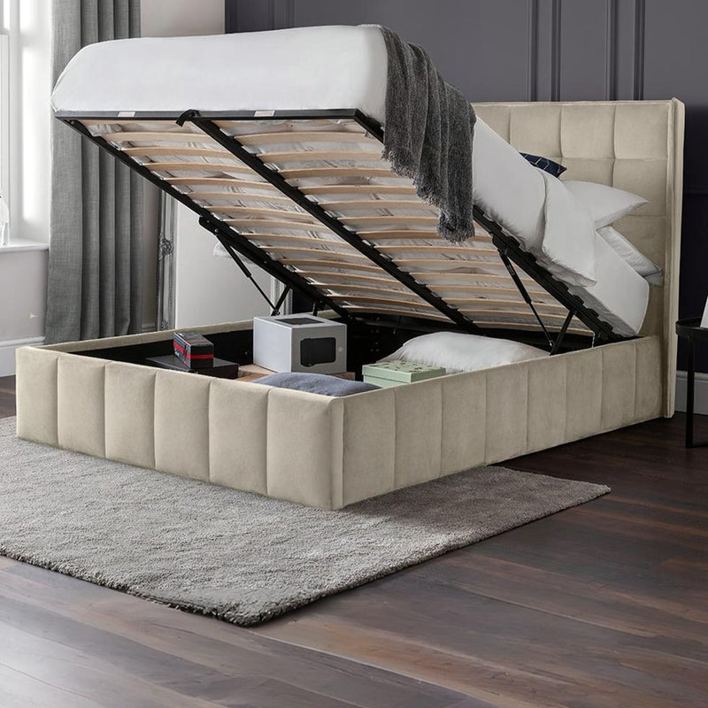 Beige upholstered bed with storage compartments in a room setting.