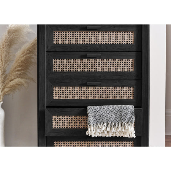 Black 5 drawer chest with woven rattan drawers in modern bedroom