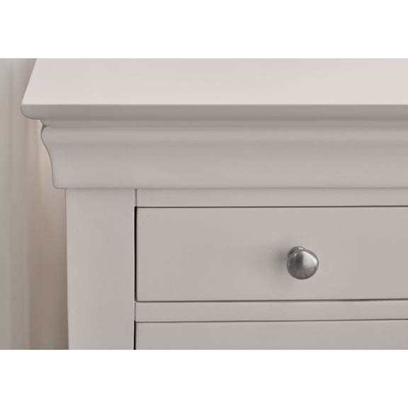 Close-up of a light gray drawer with a silver handle on a white background