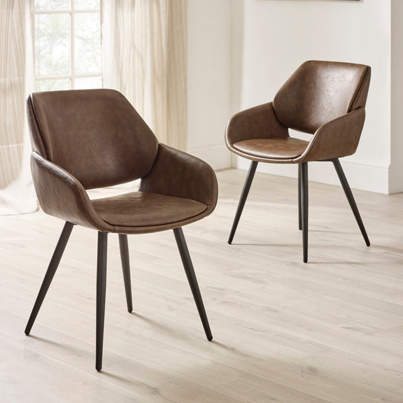 Two brown chairs with black legs on a light wooden floor.