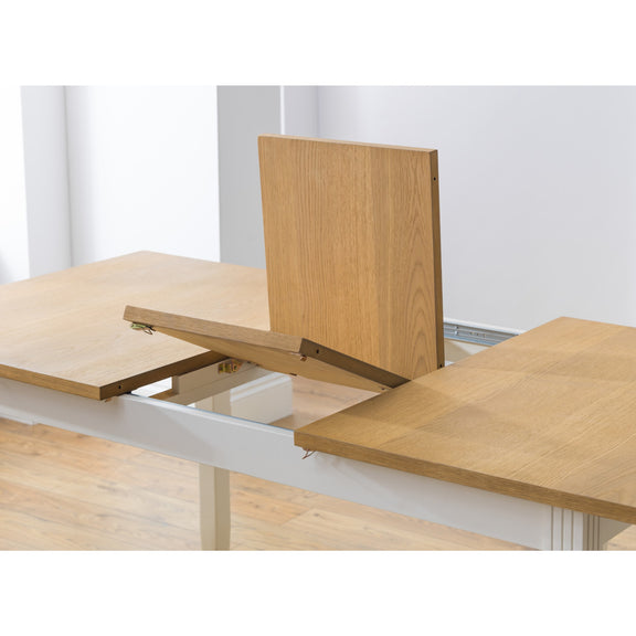 Wooden table with an extended leaf on a white background