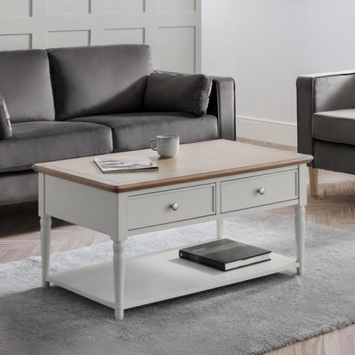 Gray sofa and coffee table with a rug in a living room setting