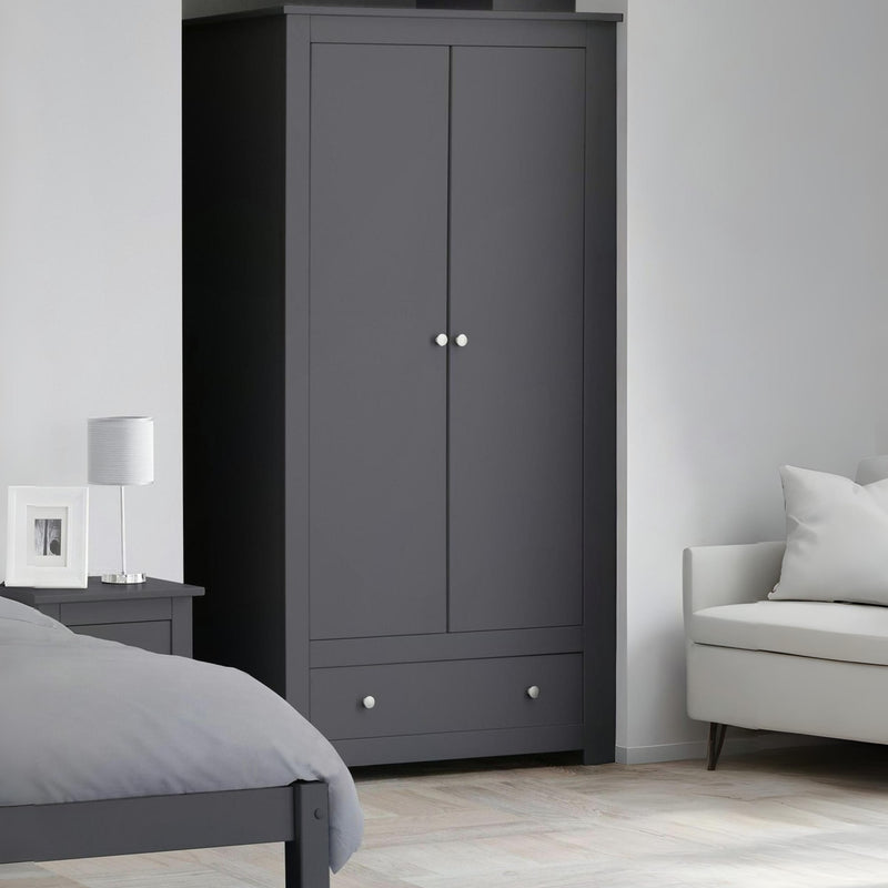 Gray wardrobe in a bedroom with a bed and sofa.