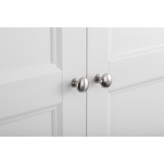 Close-up of a white cabinet with silver knobs on a white background