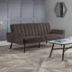 Brown sofa in a room with a hexagonal mirror on the wall.