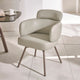 Modern beige chair with metal legs on a light tiled floor.