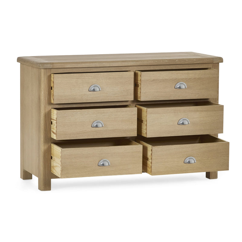 Wooden dresser with six drawers on a white background