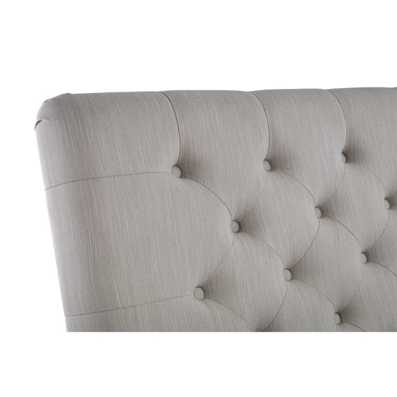 Gray tufted headboard on a white background