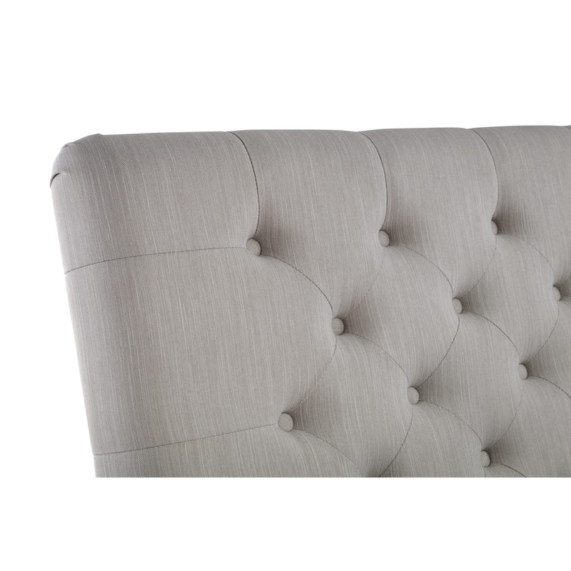 Gray tufted headboard on a white background