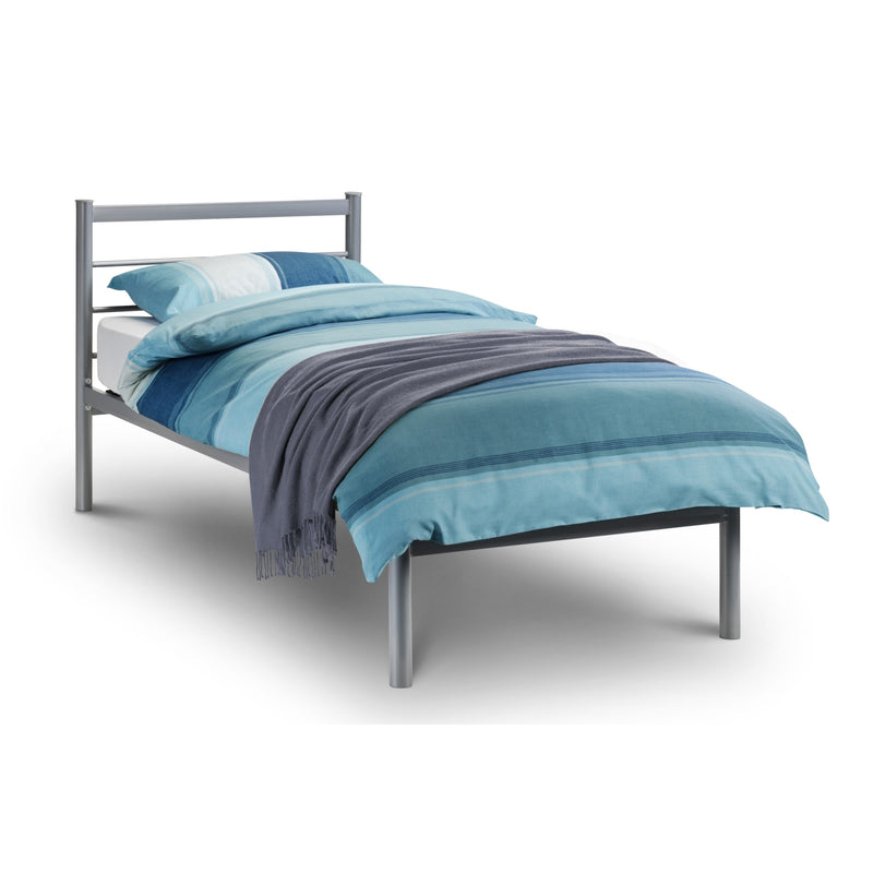 Bed with blue bedding and a gray frame on a white background