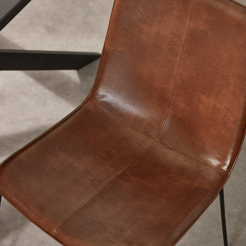 Brown leather chair on a gray floor