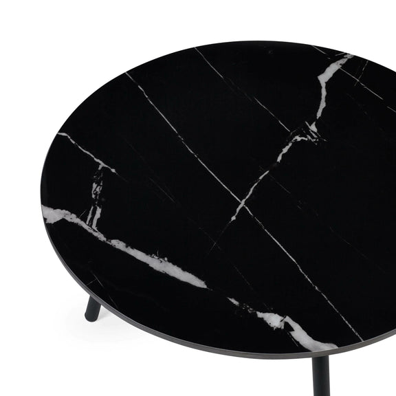 Round black marble table on a white background
