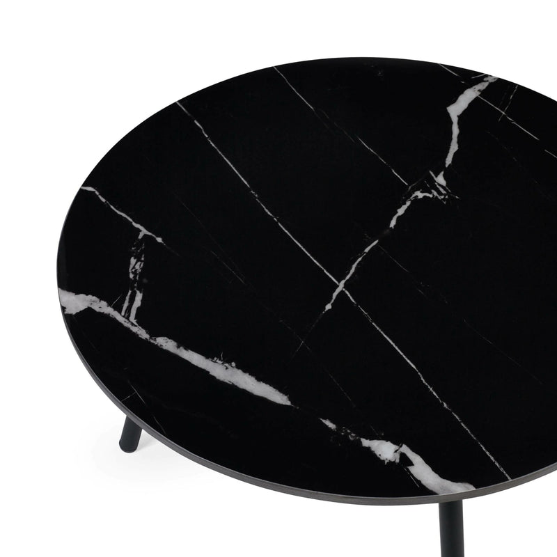 Round black marble table on a white background