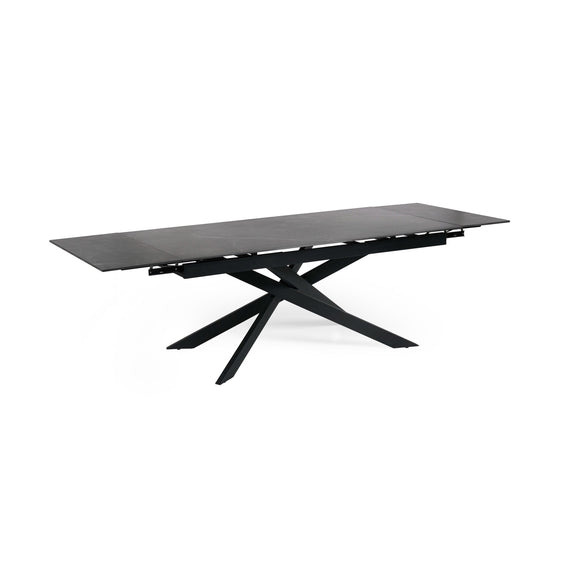 Black dining table with unique star-shaped base on a white background