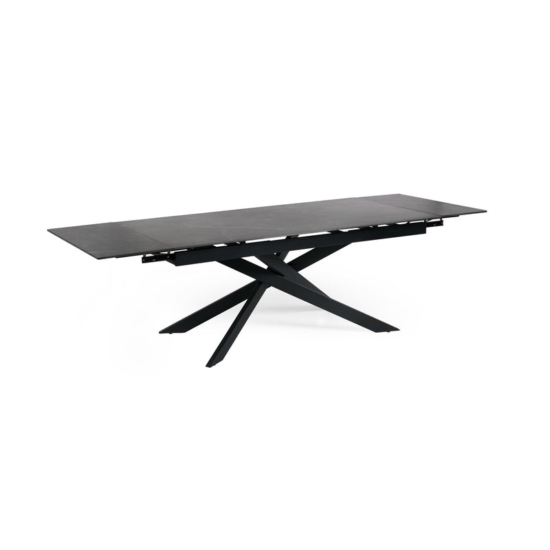 Black dining table with unique star-shaped base on a white background