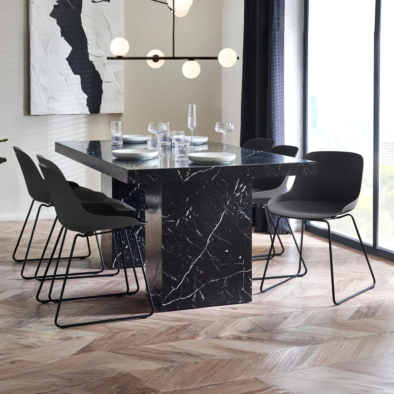 Modern dining room with black marble table and chairs.
