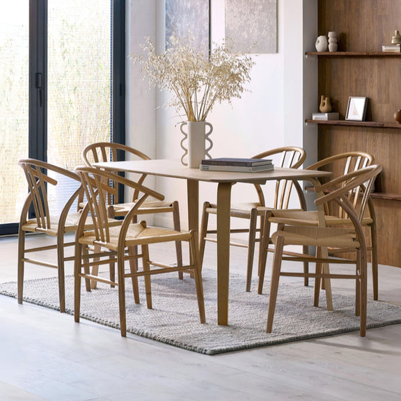 Dining area with wooden table and chairs in a modern room.