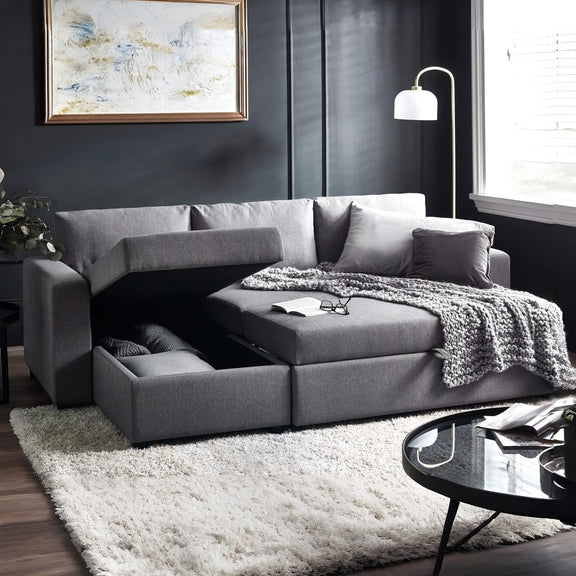 Gray sectional sofa in a living room with a rug and coffee table.