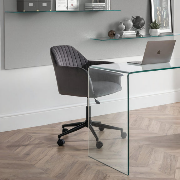 Modern office setup with a glass desk and gray chair.