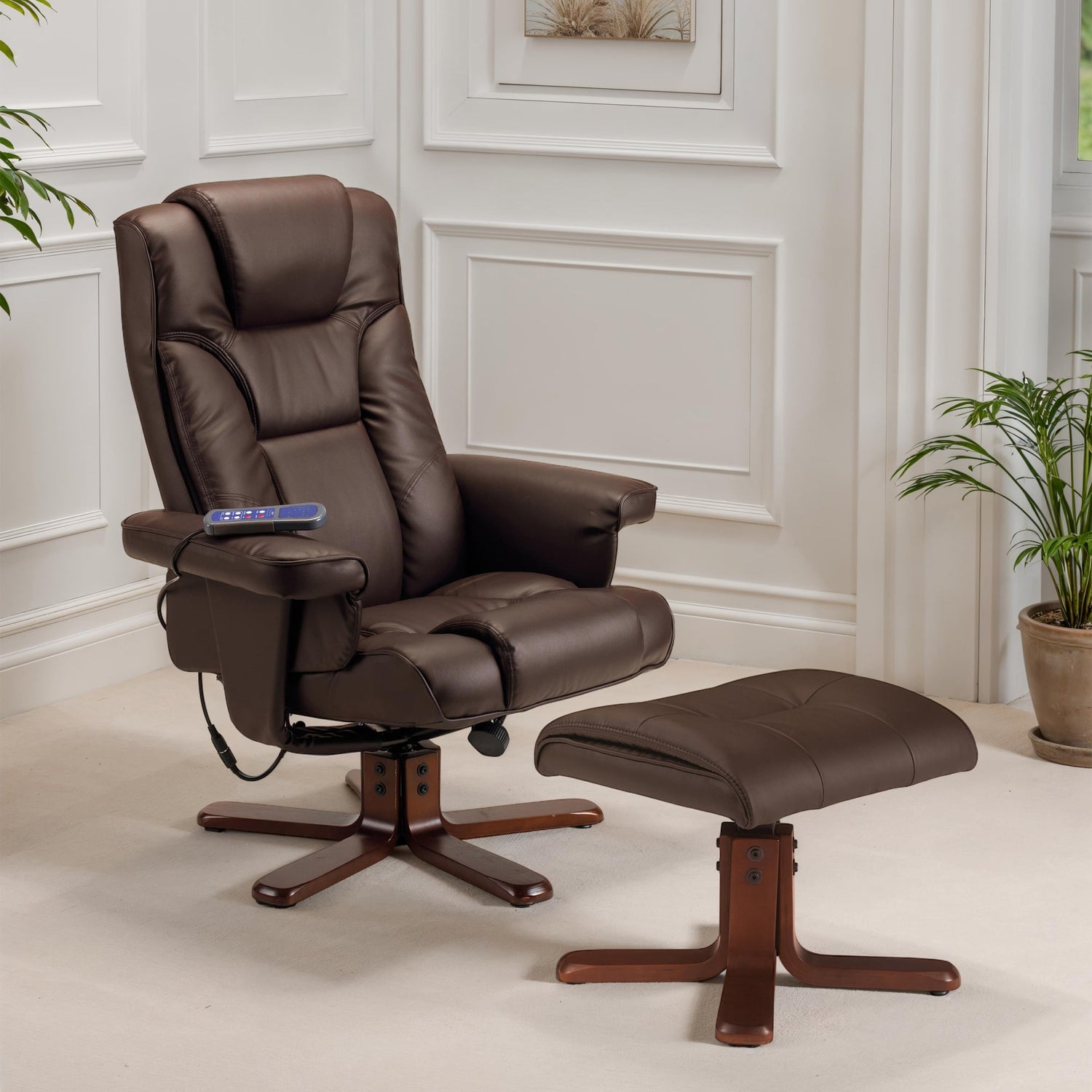 Brown leather recliner chair with ottoman in a room with white walls and plants.