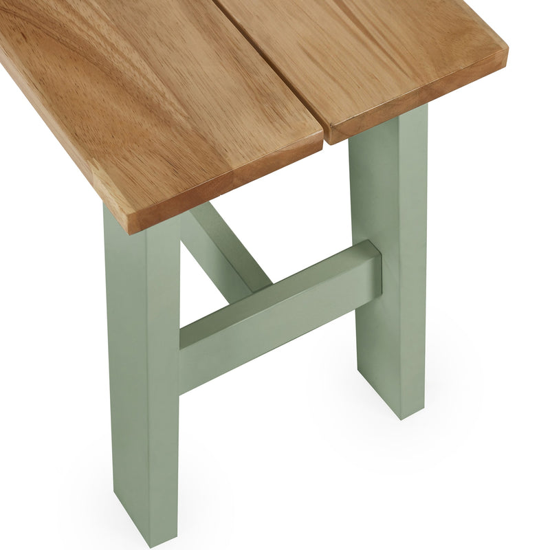 Wooden stool with a green base on a white background